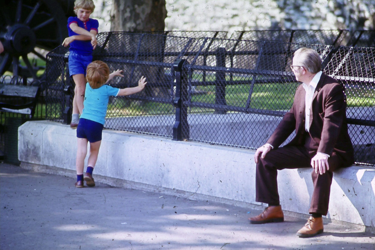 Kid playing in the street with dad.