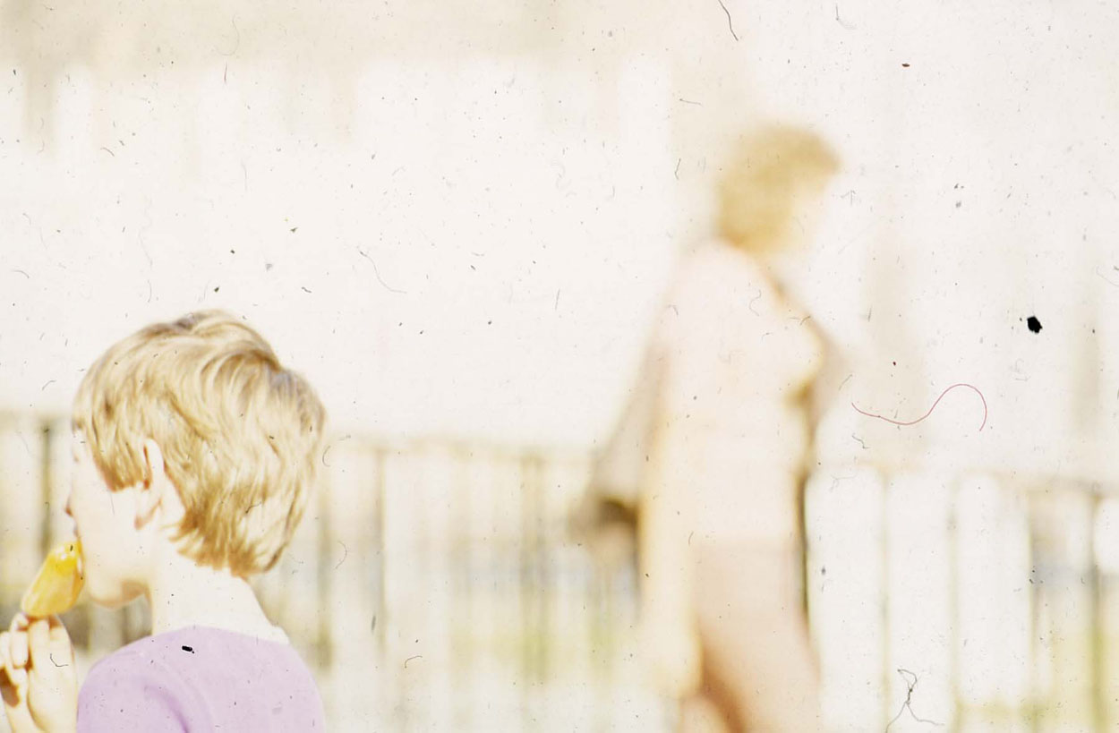 Almost daytime solorisation of a slide with a boy and a woman.