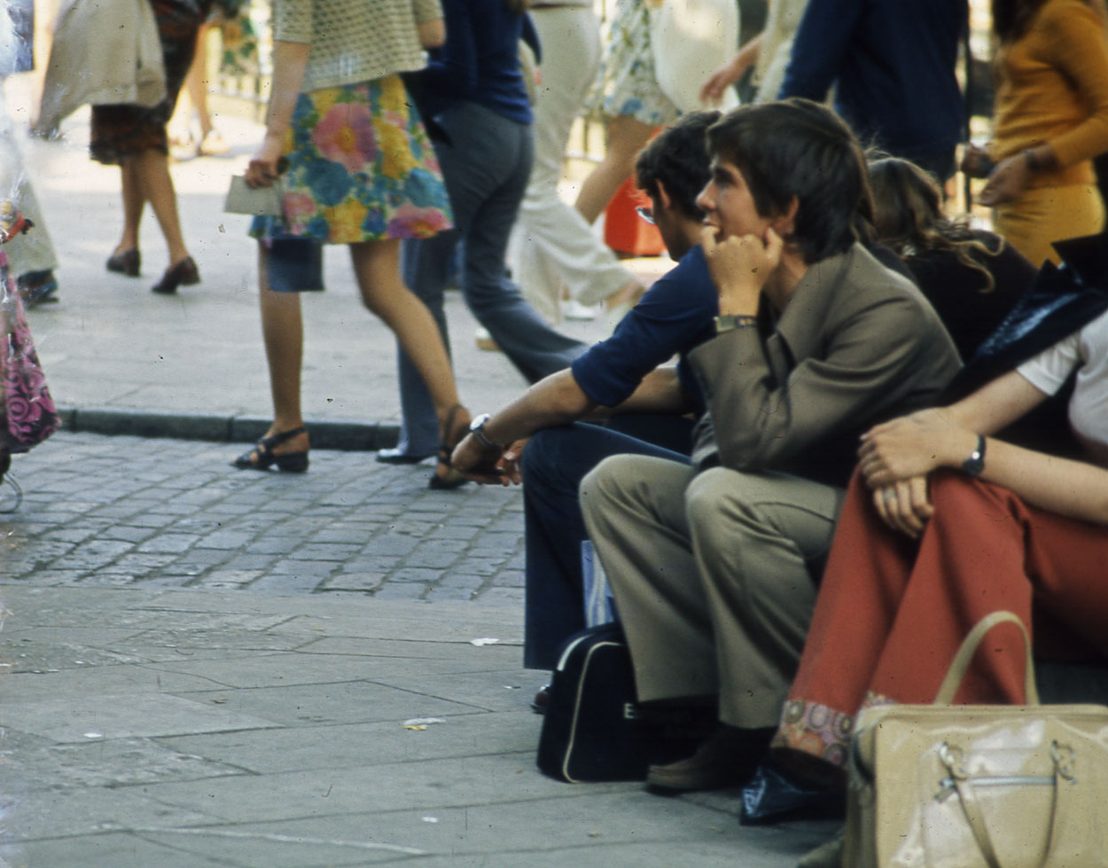 People sat  in the street - London.