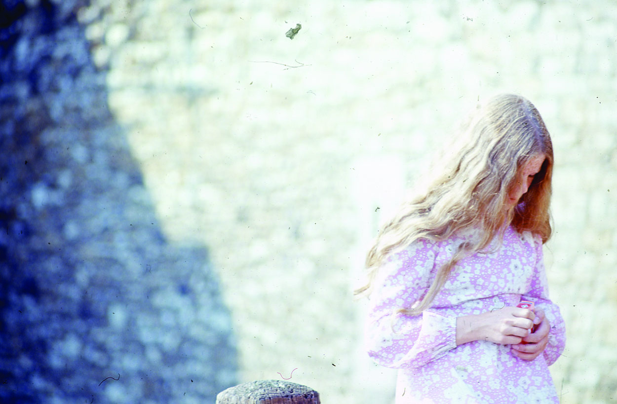 Long haired girl with bollard.